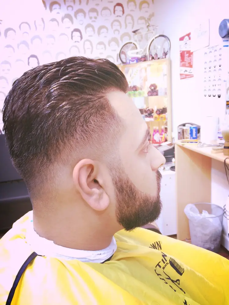 Profile of a customer with a slicked-back cut and trimmed beard